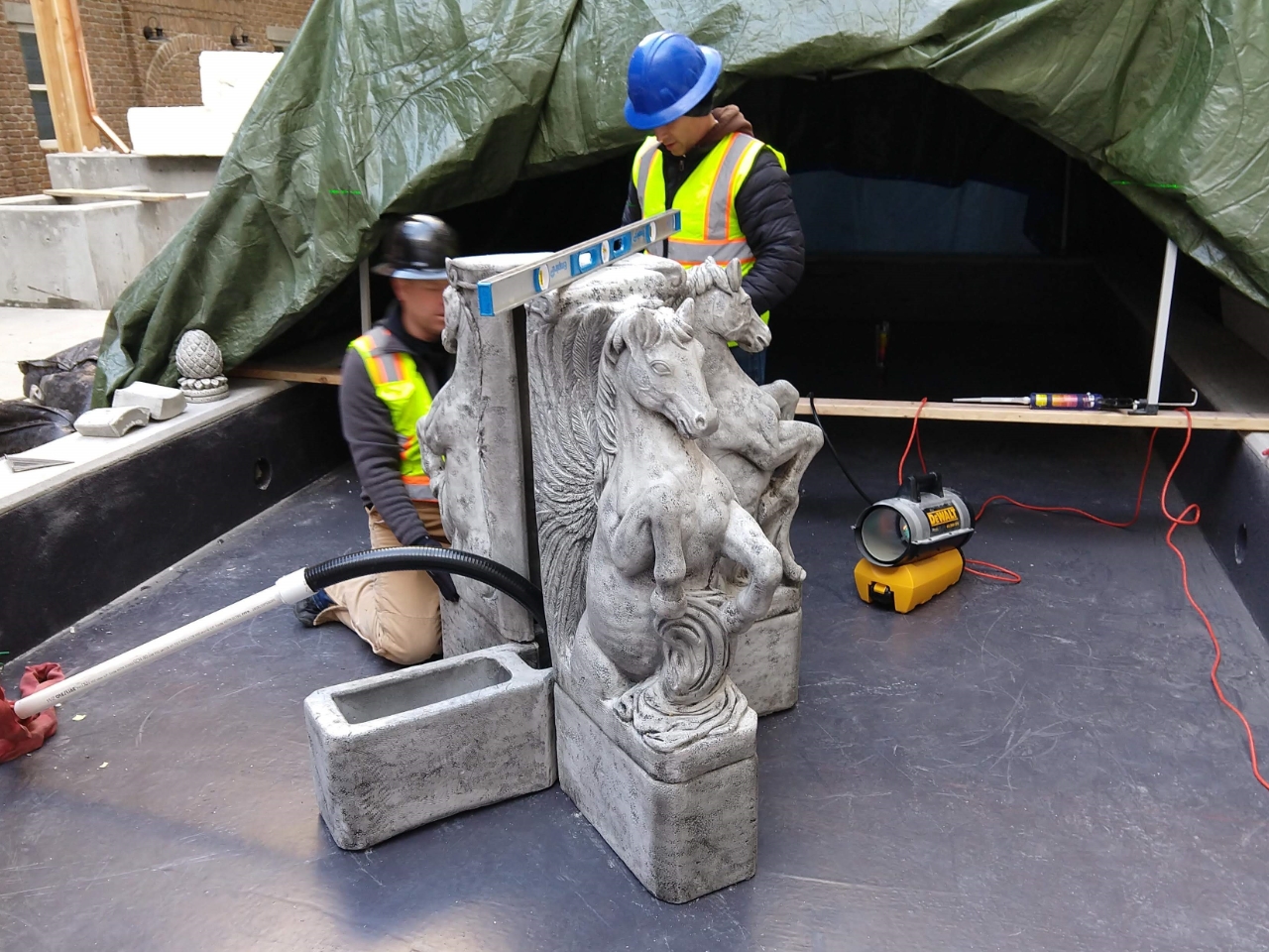 fountain construction with 2 workers