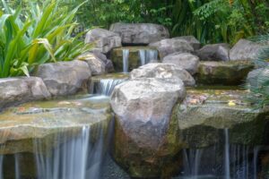 Waterfall,and,sword,in,the,stone,garden,feature.